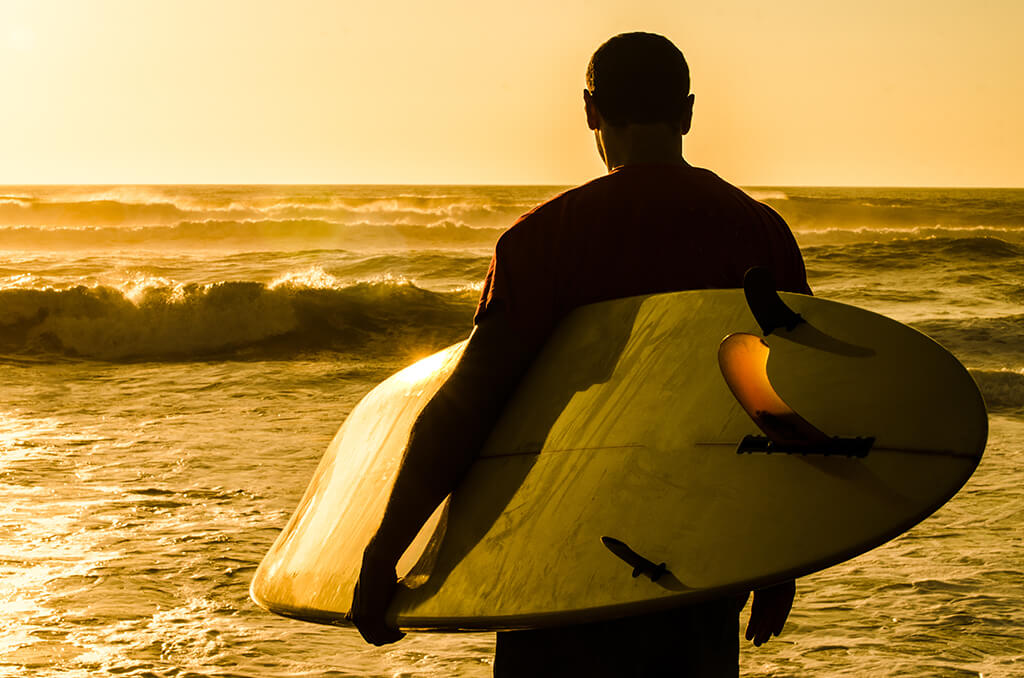 Surfer looking out at waves